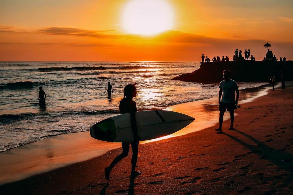 People enjoying surfing in Bali, Indonesia